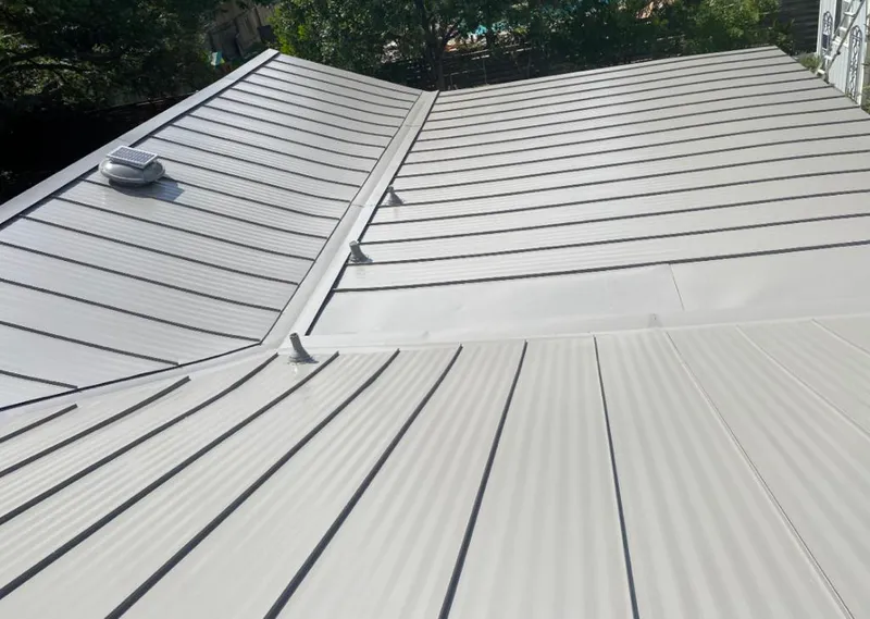 Solar attic fan installed on a metal roof for Roof Ventilation in Montrose-Ghent